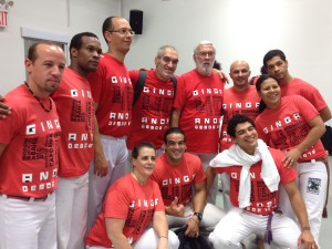 A group of people wearing red shirts and white pants.